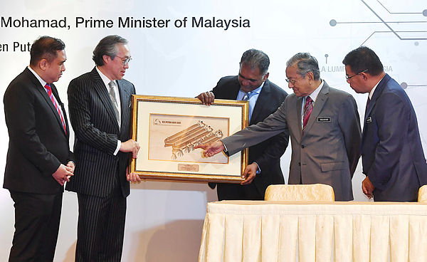 Prime Minister Tun Dr Mahathir points to a picture of the proposed STS Hub in Johor, on April 2, 2019. — Bernama