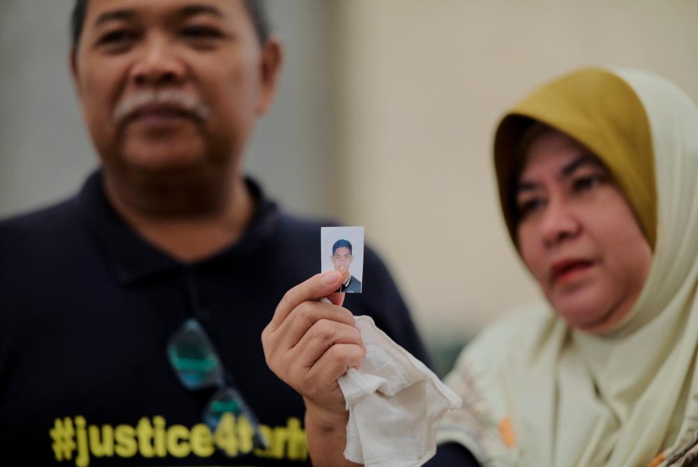 The father of the murder victim, Zulfarhan Osman Zulkarnain, who was also a former student of the National Defense University of Malaysia (UPNM), Zulkarnain Idros, and his wife, Hawa Osman, show a picture of their late son after the Court of Appeal sentenced six former UPNM students to death by hanging at the Istana Putrajaya judiciary today - BERNAMApix