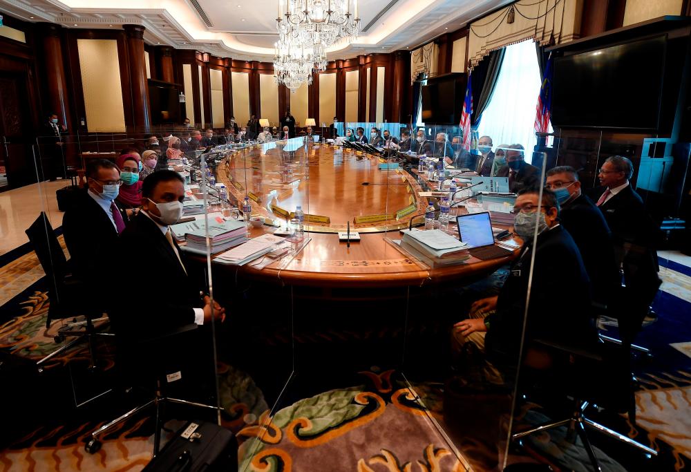 Prime Minister Tan Sri Muhyiddin Yassin when chairing the cabinet meeting at Perdana Putra here today. The meeting was held in new norms with translucent barriers. - Bernama