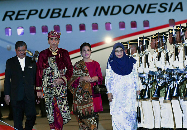Indonesian President Joko Widodo and his wife Iriana Joko Widodo arrive at the KLIA Bunga Raya Complex today for a two-day official visit to Malaysia. On hand to welcome them are Defence Minister Mohamad Sabu and wife Normah Alwi. — Bernama