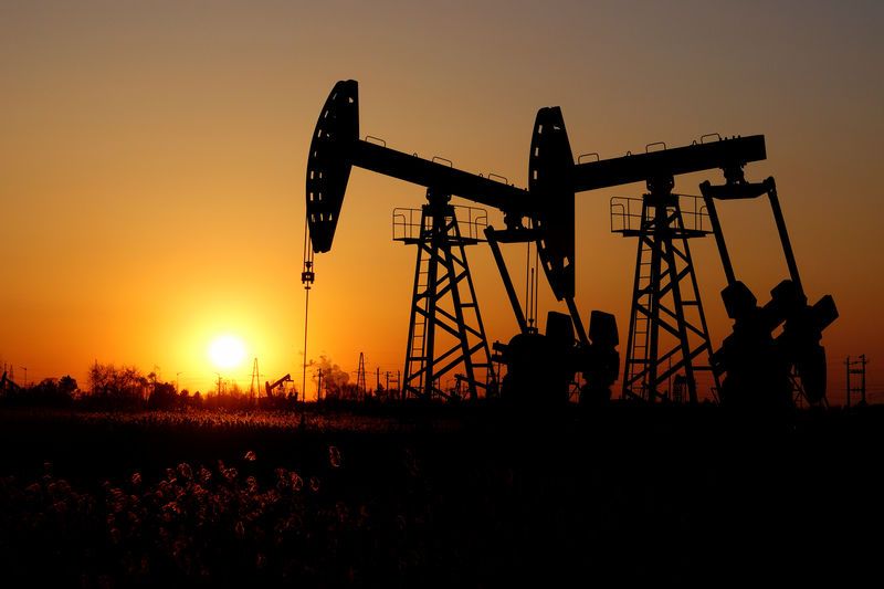Pumpjacks are seen against the setting sun at the Daqing oil field in Heilongjiang province, China December 7, 2018. Picture taken December 7, 2018. REUTERS/Stringer