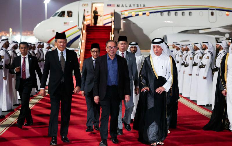 Prime Minister Datuk Seri Anwar Ibrahim disembarks from his plane as he arrives at the Doha International Airport on Sunday night. - fotoBERNAMA