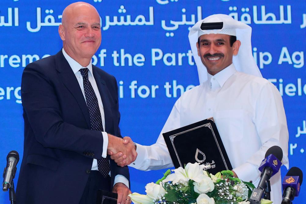Kaabi and Descalzi during a signing ceremony at the QatarEnergy headquarters in Doha yesterday. AFPpix