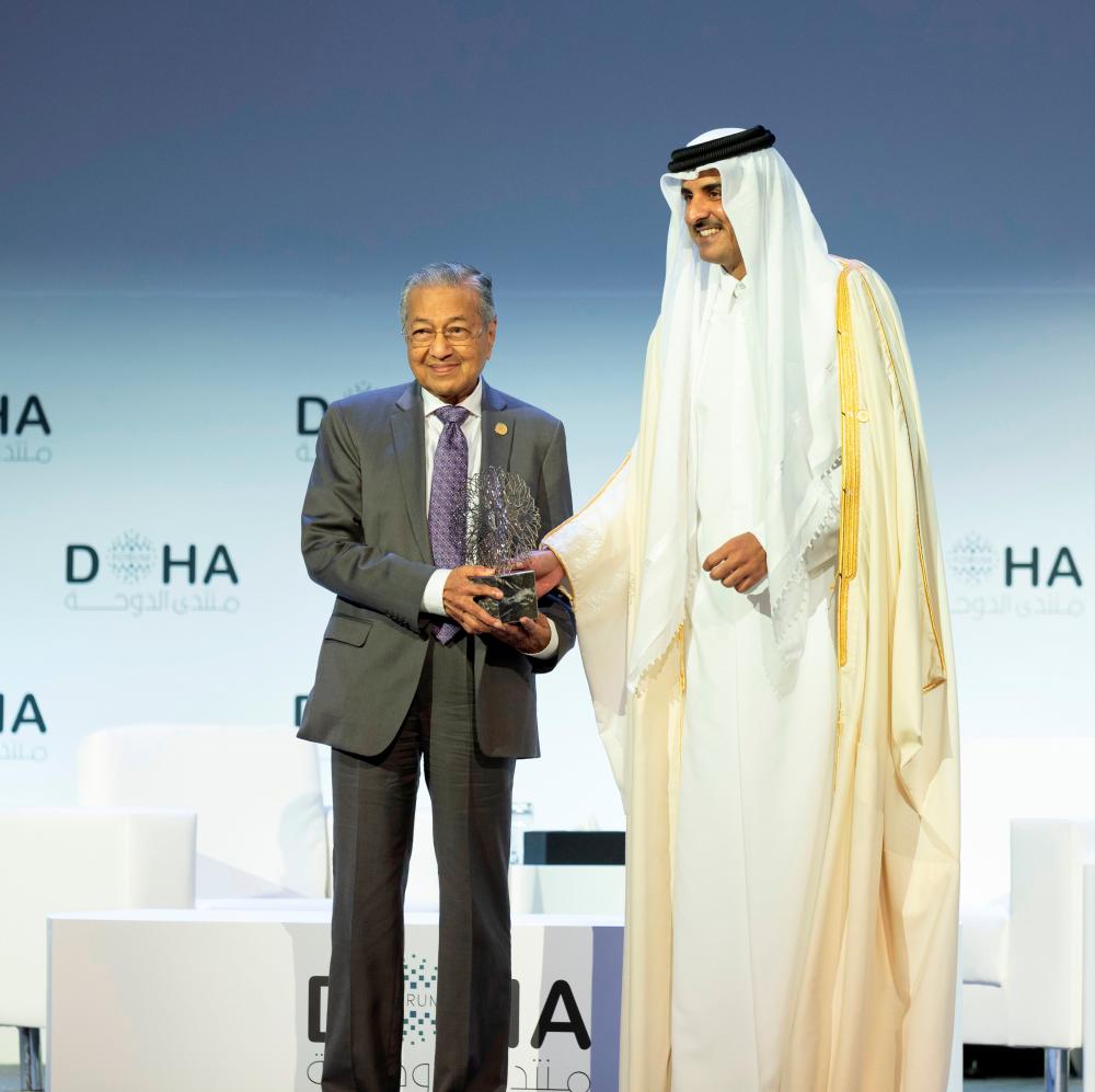 Qatar's Emir Sheikh Tamim bin Hamad al-Thani, honours Prime Minister Tun Dr Mahathir Mohamad during the opening of the Doha Forum, in Doha, Qatar, December 14, 2019. - Reuters