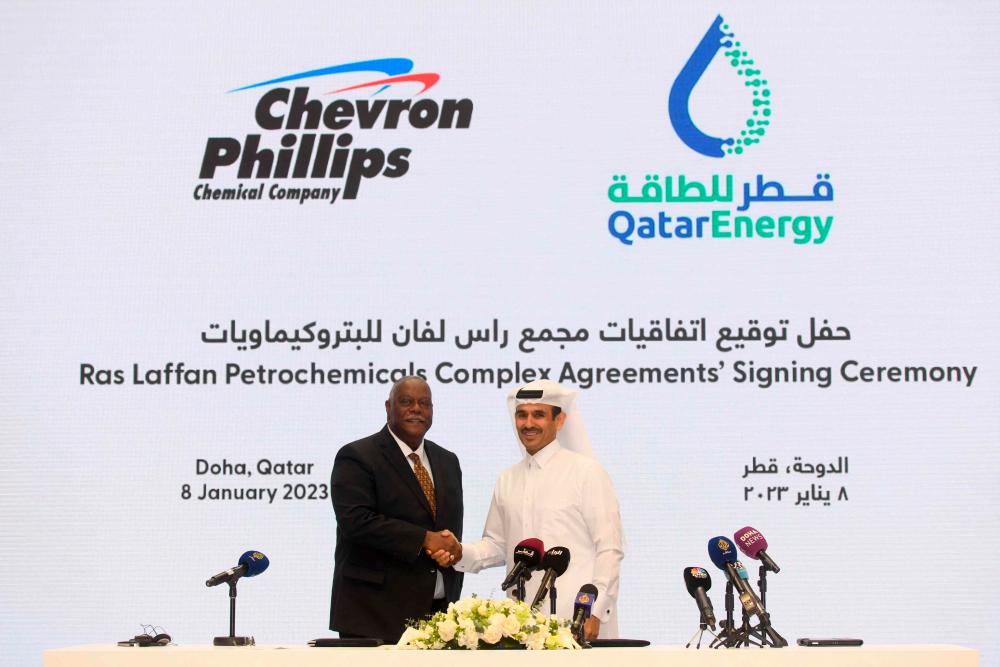 Kaabi (right) and Bruce Chinn, CEO of Chevron Phillips Chemical, during a signing ceremony at the QatarEnergy headquarters in Doha on Sunday, Jan 8. – AFPpic