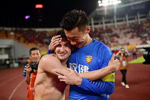 This photo shows Tianjin Quanjian’s Alexandre Pato (L) and goalkeeper Zhang Lu hugging after the AFC Champions League round of 16 football match between China’s Guangzhou Evergrande and Tianjin Quanjian in Guangzhou in China’s southern Guangdong province. When Brazilian star Alexandre Pato jetted out of China for his holidays he played for Tianjin Quanjian. — AFP