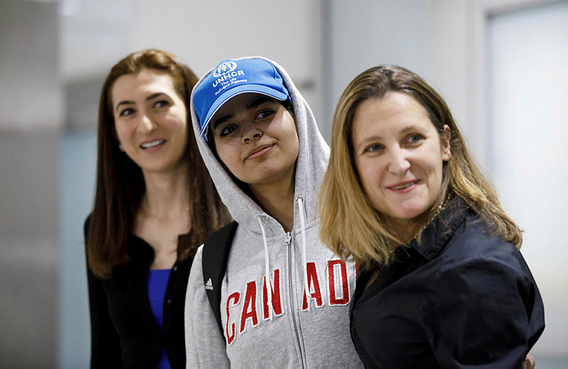 Asylum Seeker Rahaf Mohammed al-Qunun, 18, smiles as she is introduced to the media at Toronto Pearson International Airport, alongside Canadian minister of Foreign Affairs Chrystia Freeland, right, on Jan 12, 2019, in Toronto. — AFP
