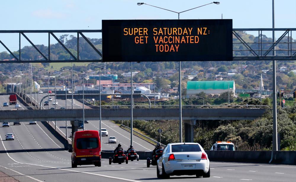 A sign on an Auckland motorway urges people to get vaccinated at a coronavirus disease (Covid-19) vaccination clinic during a single-day vaccination drive, aimed at significantly increasing the percentage of vaccinated people in the country, in Auckland, New Zealand, October 16, 2021. REUTERSPix