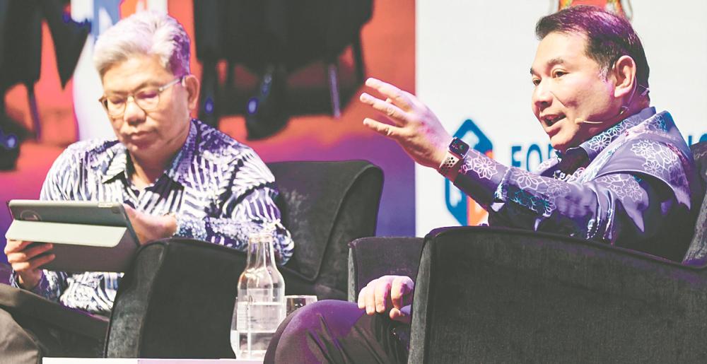 Rafizi (right) speaking during a fireside chat at Malaysia Economic Forum 2025 moderated by Maybank president and group CEO Datuk Khairussaleh Ramli in Kuala Lumpur today – Bernamapic