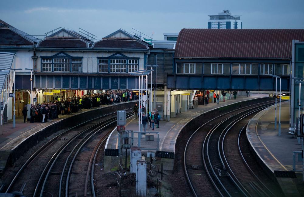 In this file photo taken on January 10, 2017 A platform normally used by Southern Rail (R) is empty of passengers as commuters (L) wait for a train on a platform run by another operator at Clapham Junction station in London during strike action by Southern Rail. AFPpix