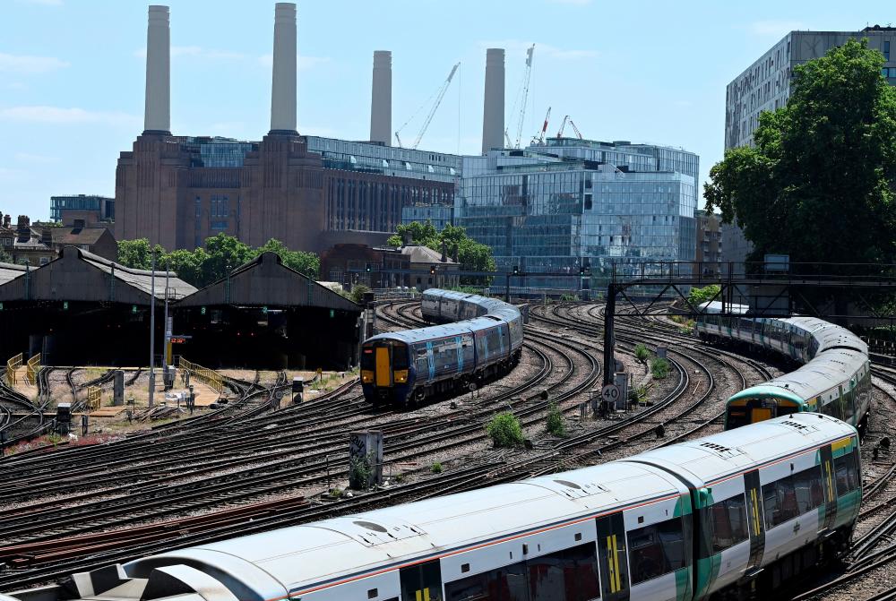Trains are seen with Battersea Power Station behind, ahead of a planned national strike by rail workers, near Victoria Station, in London, Britain, June 20, 2022. REUTERSpix