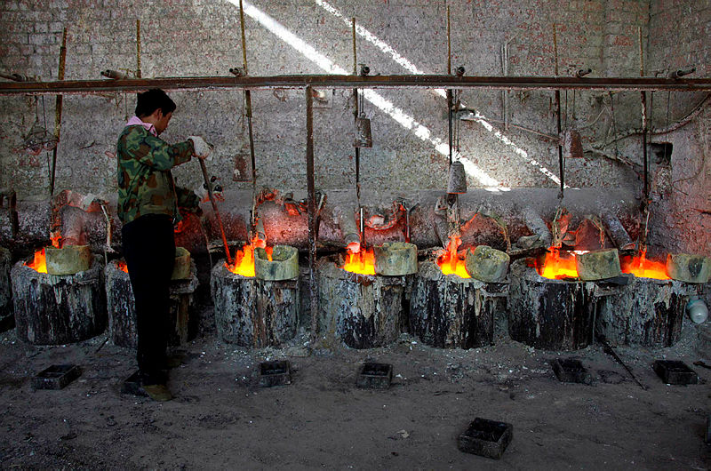 Ren Limin, a worker at the Jinyuan Company’s smelting workshop, stokes the pots containing the rare earth metal Lanthanum before he pours it into a mould near the town of Damao, located in China’s Inner Mongolia Autonomous Region Oct 31, 2010. — Reuters