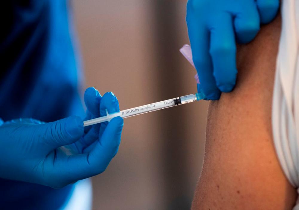 A health worker vaccinates an elderly person with Pfizer’s Covid-19 vaccine at a temporary vaccination clinic in a church in Sollentuna, north of Stockholm, Sweden March 2, 2021. REUTERSPIX