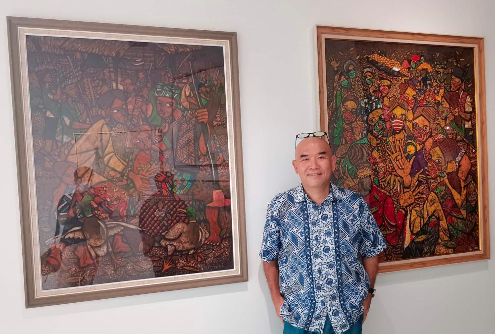 $!Lim Anuar, together with his exhibited paintings.