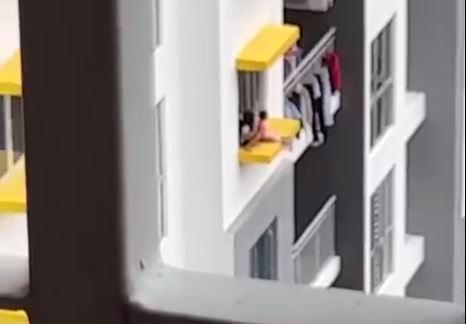 Screenshot of viral video of children playing on a 17th floor apartment window ledge in Taman Setapak, Kuala Lumpur on Oct 25 2022 - Reff Lia/Facebook