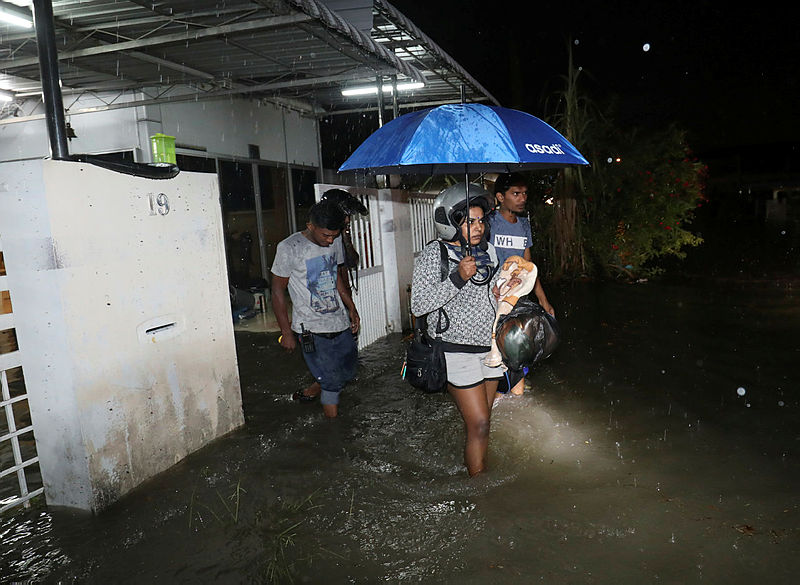 Residents of Taman Tembikai, Bukit Mertajam, evacuating their homes after a torrential downpour caused waters levels to rise, on Oct 9, 2019. — Sunpix by Masry Che Ani