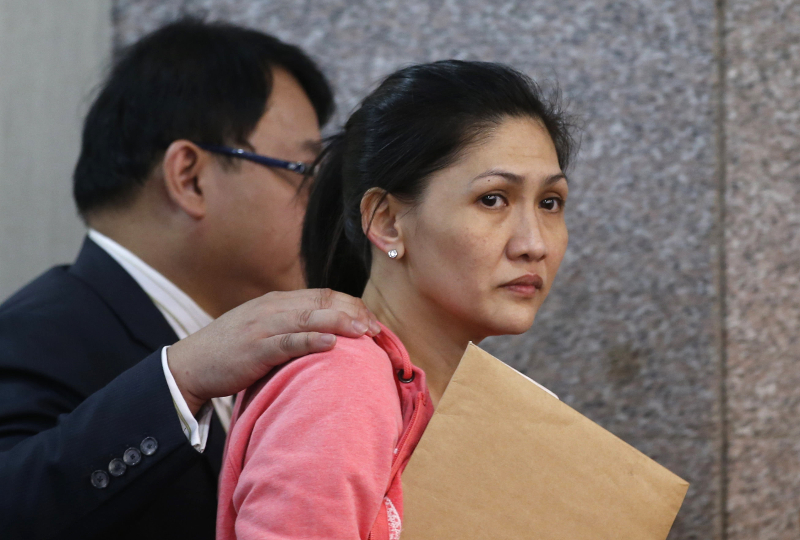 Maia Deguito, a branch manager of the Rizal Commercial Banking Corp (RCBC) is escorted by her lawyer after testifying at a Philippine Senate in Manila, Philippines, on March 17, 2016. — Reuters