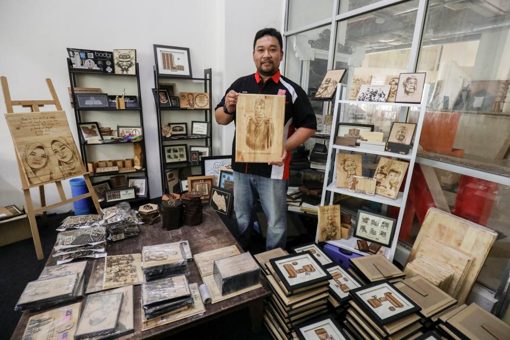 Ahmad Fazrin Abdul Rahman, the founder of Rinacraft, with his woodcraft merchandise. – HAFIZ SOHAIMI/THESUN