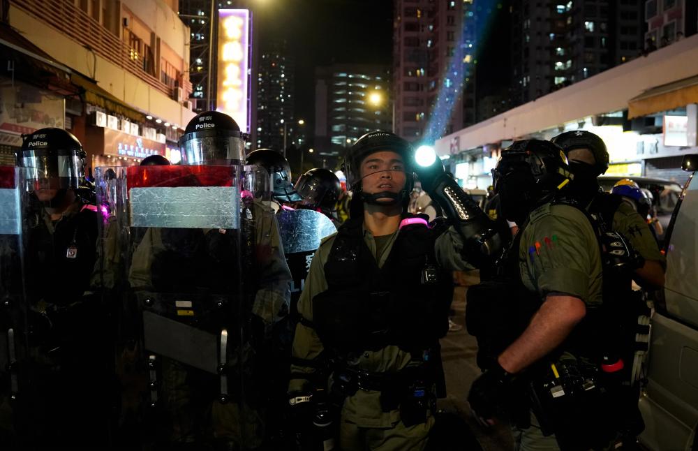Riot police officers block the street in Tuen Mun, Hong Kong, China September 21, 2019. - Reuters