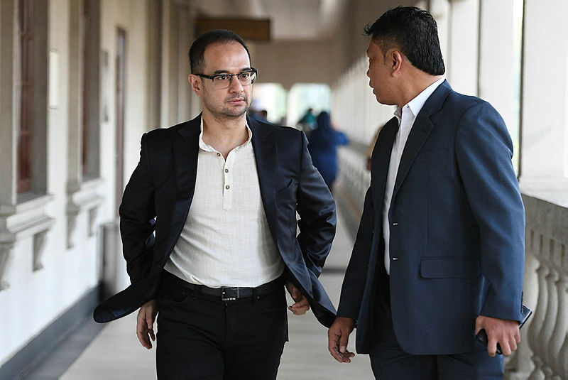 Riza Aziz (L), arrives at the sessions court in Jalan Duta, on July 5, 2019. — AFP