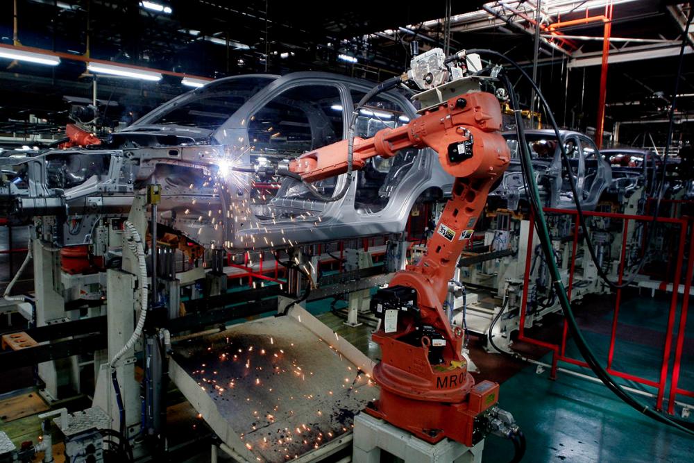 Robots weld car frames at a Proton assembly line in Shah Alam, at the outskirts of Kuala Lumpur, 27 June 2008. — AFP