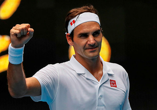 Switzerland’s Roger Federer celebrates after victory over Britain’s Daniel Evans in their men’s singles match on day three of the Australian Open tennis tournament — AFP