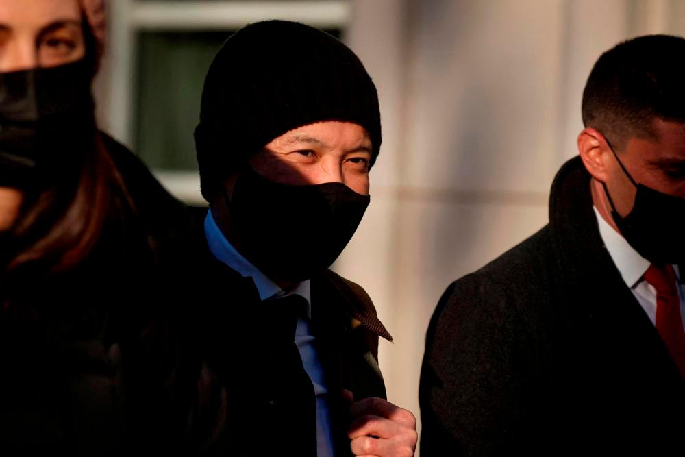 FILE PHOTO: Ex-Goldman Sachs banker Roger Ng exits after the first day of his criminal trial, at the United States Courthouse in Brooklyn, New York, U.S., February 14, 2022. REUTERSpix