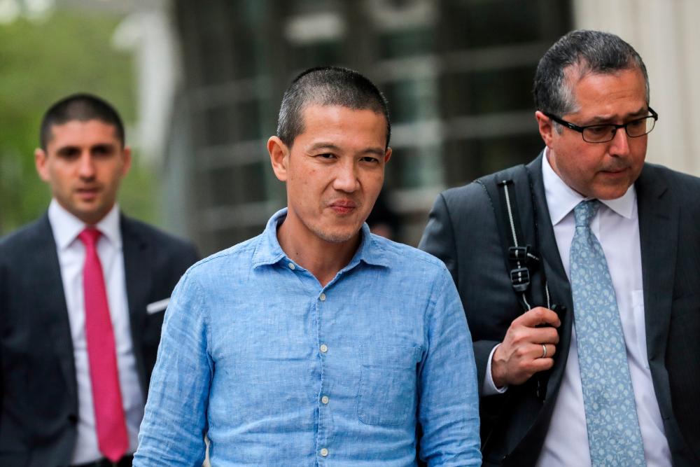 Roger Ng (C) and his lawyer Marc Agnifilo leave the federal court in New York, US, May 6, 2019. — Reuters