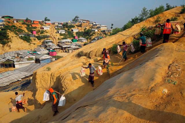 Rohingya refugees carry bricks to a construction site at the Balukhali camp in Cox’s Bazar, Bangladesh, April 8, 2019. — Reuters