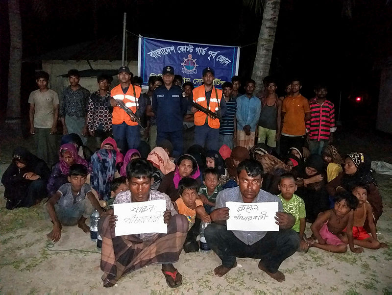 Bangladesh Coast Guard pose for a photo with rescued Rohingya refugees in Teknaf on May 31, 2019. Bangladesh coast guard have rescued 58 fortune seeking Rohingya refugees in a Malaysia-bound fishing trawler near the coast of the country’s southern island in Bay of Bengal, officials said on May 30, 2019. — AFP