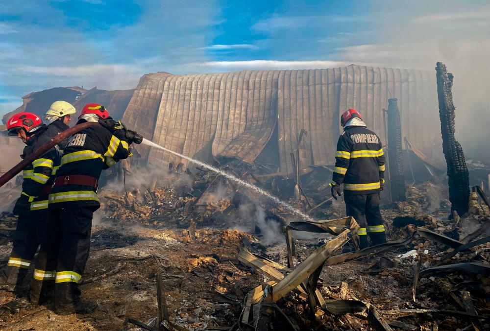 This handout photo taken and made available by the Inspectorate of Emergency Situations Prahova (ISU Prahova) on December 26, 2023 shows firemen working to extinguish a fire at the site of teh ‘Ferma Dacilor’ guest house in Tohani, Romania/AFPPix