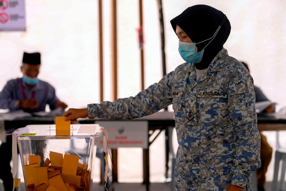 Female member of the Royal Malaysian Navy, Siti Naima Jibri casting her vote whilst adhering to the her norm according to the COVID-19 prevention guidelines during the early voting process for the Sabah state election at Sekolah Kebangsaan Pangkalan Tentera Laut Diraja Malaysia today.