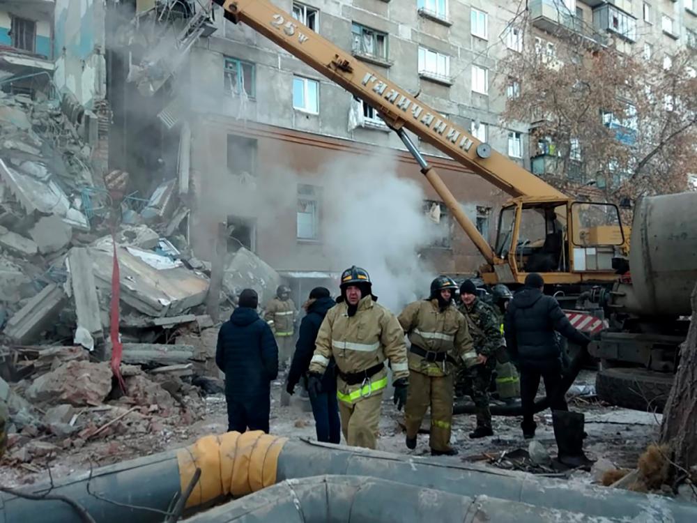 This handout picture released by The Russian Emergency Situations Ministry on Dec 31, 2018, shows emergency officers as they gather after a gas explosion rocked a residential building in Russia's Urals city of Magnitogorsk. — AFP