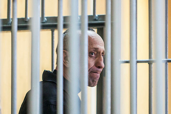 Mikhail Popkov stands inside a defendants’ cage during a court hearing in Irkutsk on Dec 10, 2018. — AFP