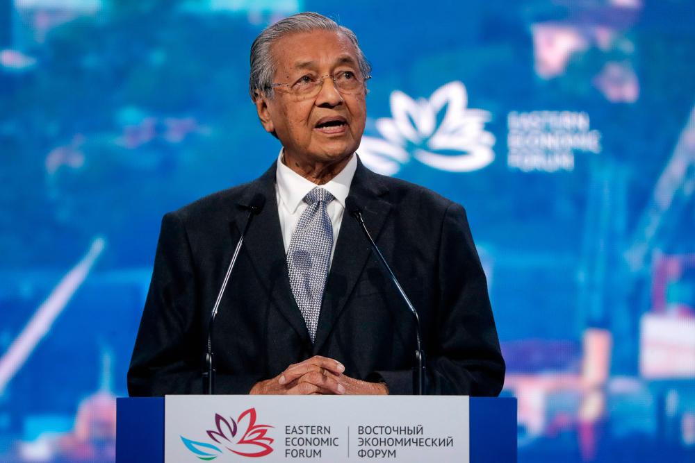 Prime Minister Tun Dr Mahathir Mohamad gives a speech as he takes part in a plenary session of Eastern Economic Forum at far-eastern Russian port of Vladivostok on Sept 5, 2019. - AFP