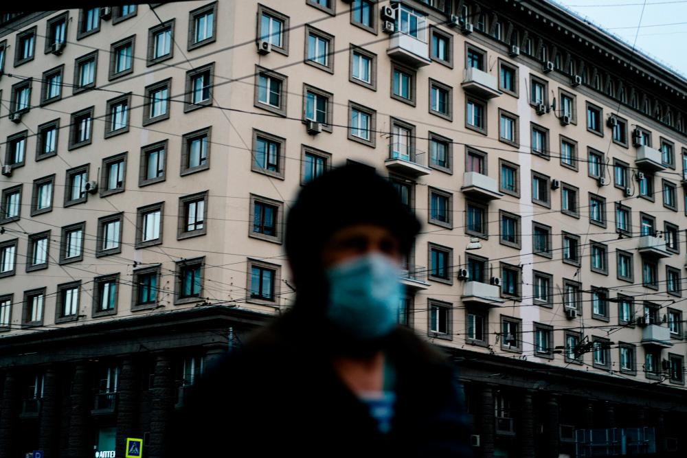 This picture taken on April 15, 2020 shows a man wearing a face mask walking in Moscow, during a strict lockdown in Russia to stop the spread of the novel coronavirus Covid-19. - AFP