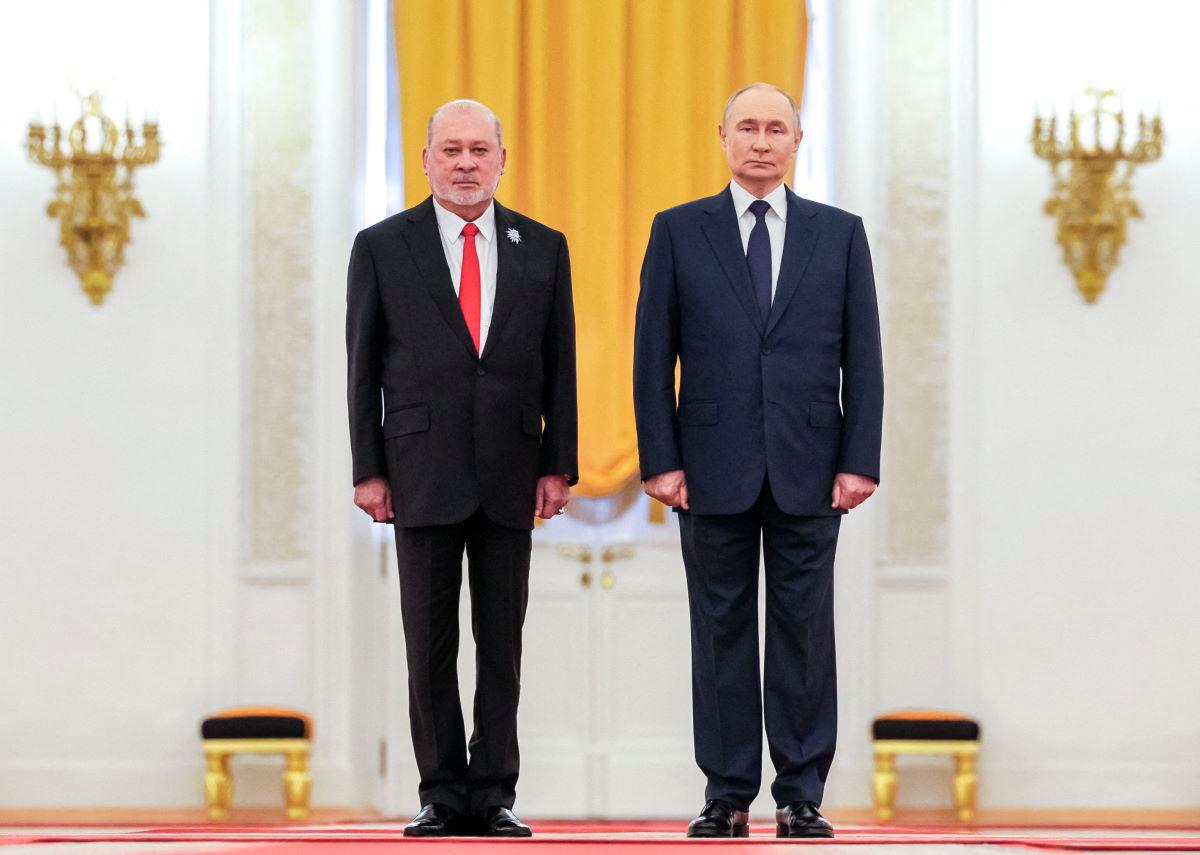 In this pool photograph distributed by the Russian state agency Sputnik, Russia’s President Vladimir Putin and Malaysia’s King Sultan Ibrahim attend a welcoming ceremony prior to their talks at the Kremlin in Moscow on August 6, 2025. - Pool via AFP