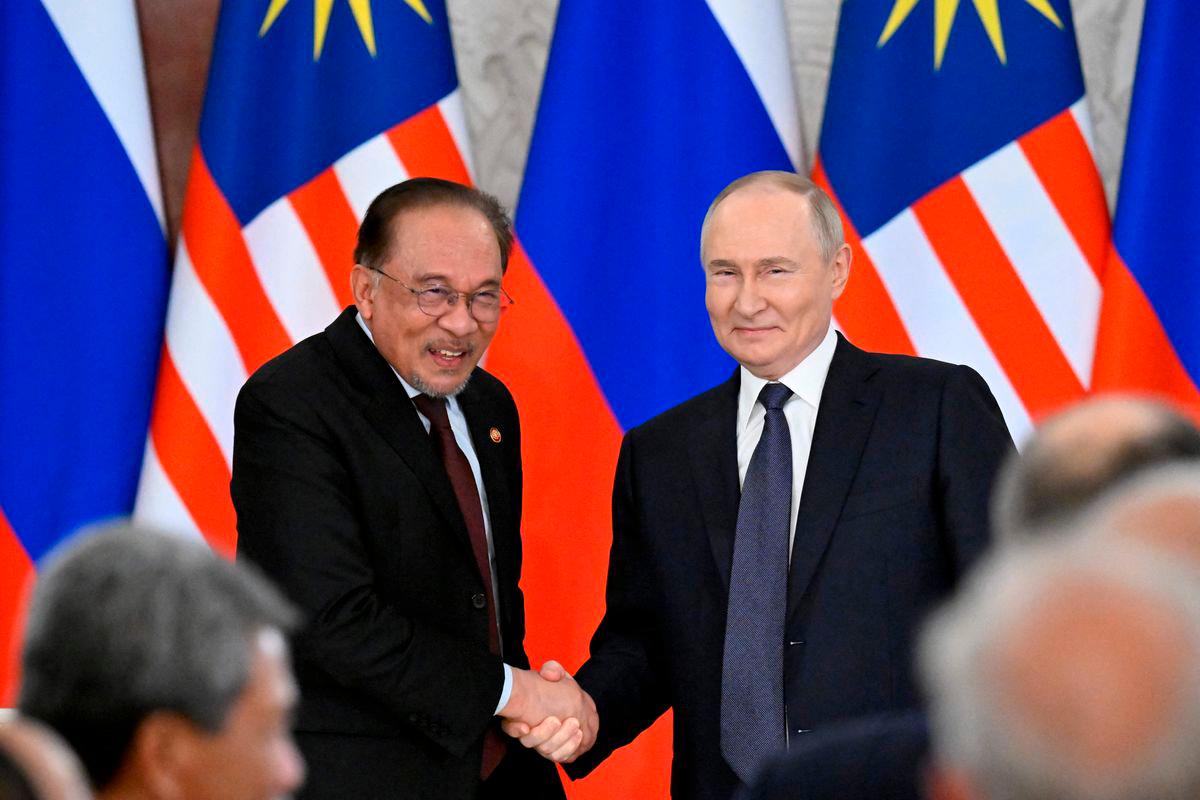 Russian President Vladimir Putin and Malaysia’s Prime Minister Anwar Ibrahim shake hands after a joint media statement following their talks at the Kremlin in Moscow on May 14, 2025. (Photo by Alexander NEMENOV / POOL / AFP)