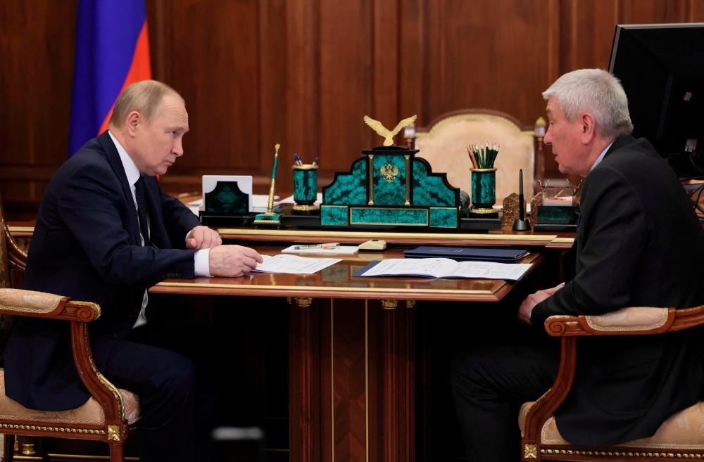 Russian President Vladimir Putin (L) meets with Head of Federal Financial Monitoring Service Yury Chikhanchin at the Kremlin in Moscow on June 27, 2022. AFPPIX