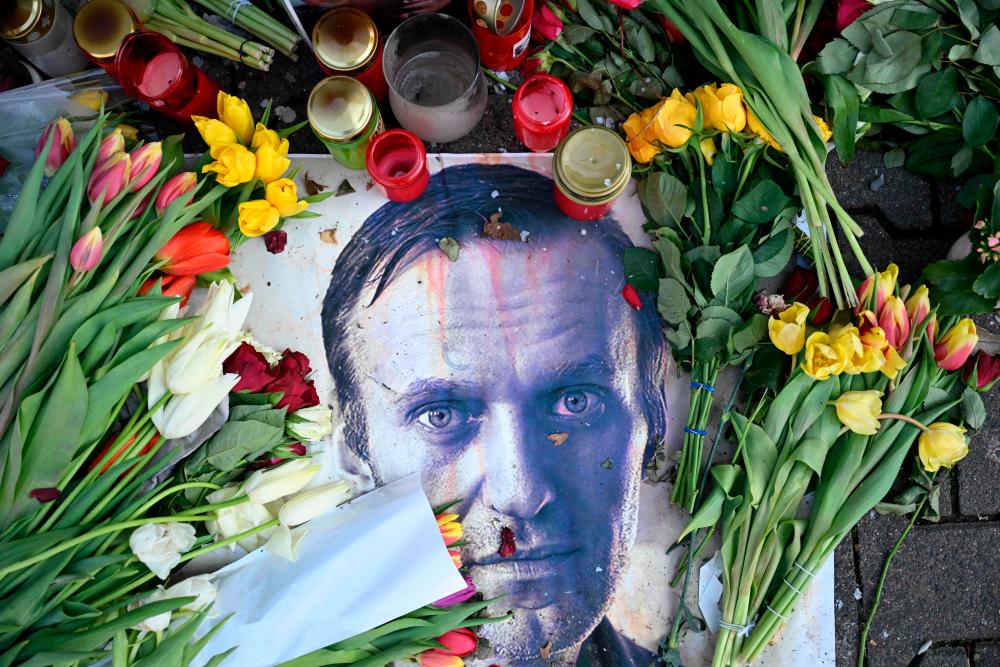 Flowers are seen placed around a portrait of late Russian opposition leader Alexei Navalny at a makeshift memorial in Frankfurt am Main, western Germany, on February 29, 2024/AFPpix