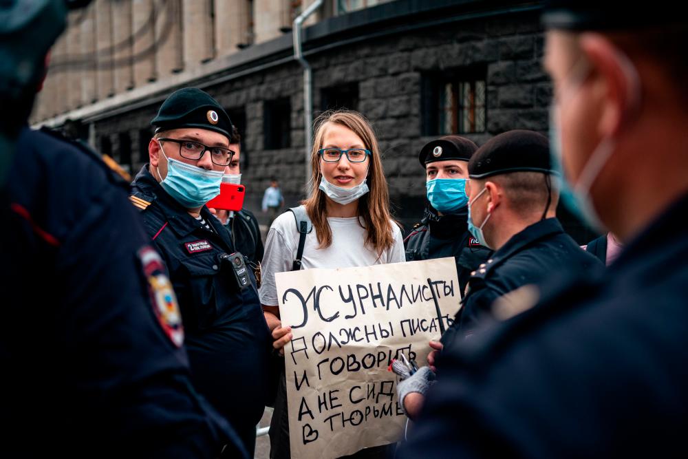 Police officers detain a supporter of Ivan Safronov, a former journalist and aide to the head of Russia's space agency Roscosmos, outside the headquarters of Russia's Federal Security Services (FSB) in central Moscow on July 7, 2020. — AFP