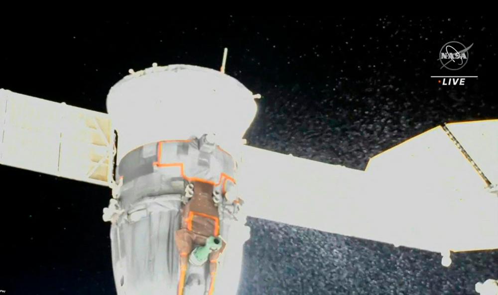 Video grab from a NASA feed obtained December 15, 2022 shows liquid spraying from the aft end of the Soyuz MS-22 spacecraft. AFPPIX