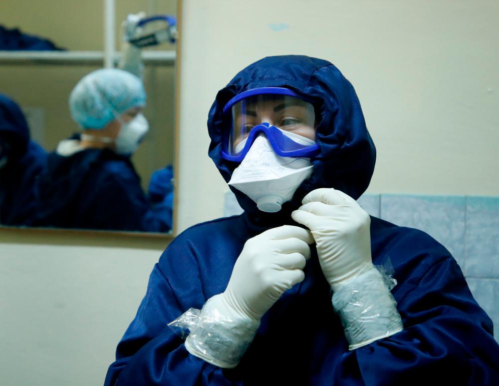 A medical specialist puts on personal protective equipment (PPE) at the Vologda City Hospital Number 1, where patients suffering from the coronavirus disease (Covid-19) are treated, in Vologda, Russia November 24, 2020. — Reuters