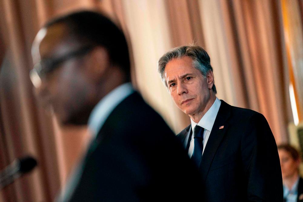 US Secretary of State Antony Blinken (R) listens as Rwanda’s Minister of Foreign Affairs Vincent Biruta (L) speaks during a news conference at the Ministry of Foreign Affairs and International Cooperation in Kigali, Rwanda, on August 11, 2022. AFPPIX