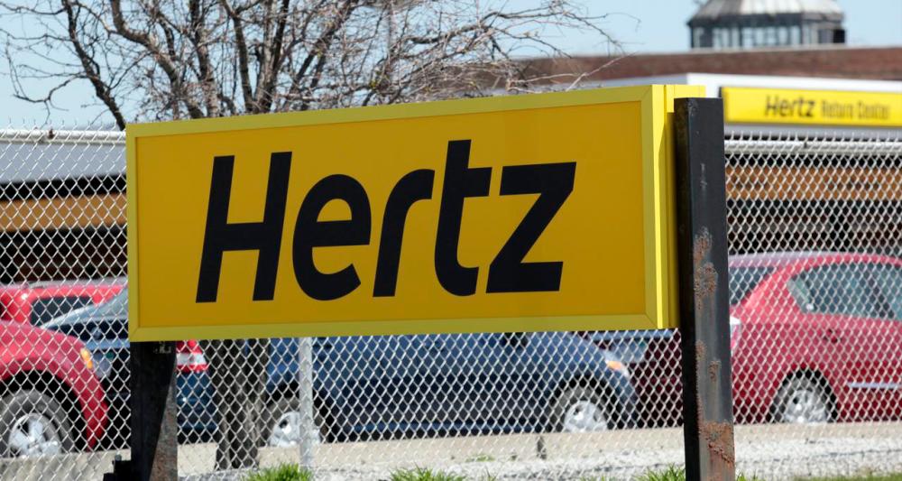 A Hertz rental car sign is placed outside a rental lot near Detroit Metropolitan airport in Romulus, Michigan May 9, 2011. -Reuters