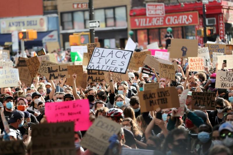 Protesters hold placards as they rally against the death in Minneapolis police custody of George Floyd, in the Manhattan borough of New York City, U.S., June 2, 2020. -Reuters