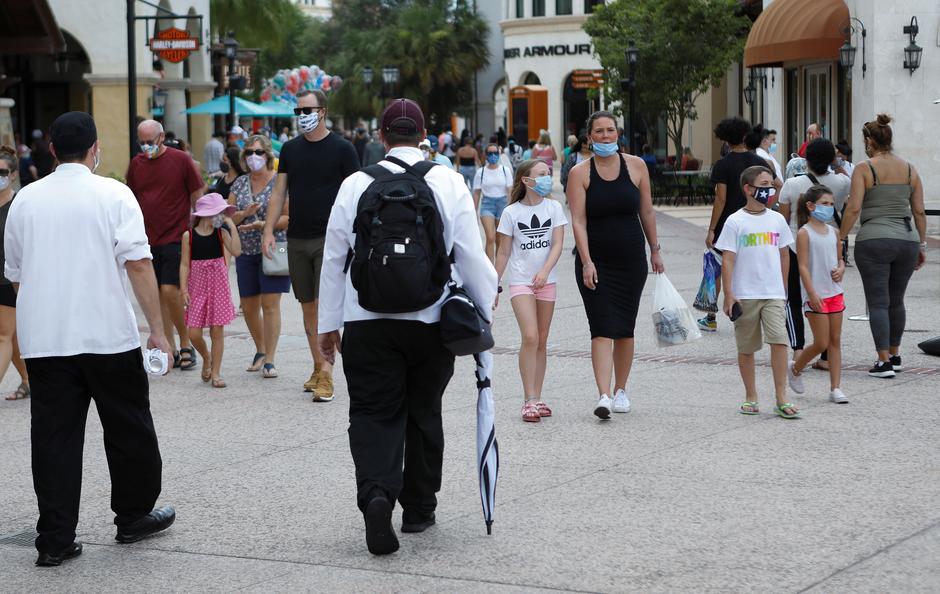 Guests wear face masks while visiting the Disney Springs shopping and dining complex at Walt Disney World during its phased reopening from coronavirus disease (COVID-19) restrictions in Lake Buena Vista, Florida, U.S. July 11, 2020. -Reuters