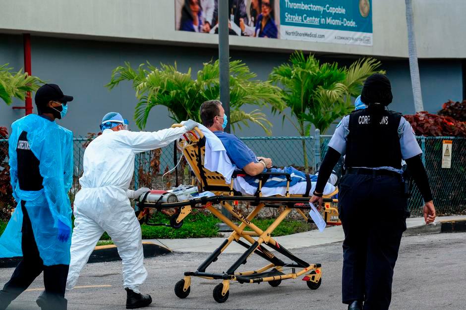 Emergency Medical Technicians (EMT) arrive with a correctional patient at North Shore Medical Center where the coronavirus disease (COVID-19) patients are treated, in Miami, Florida, U.S. July 14, 2020.