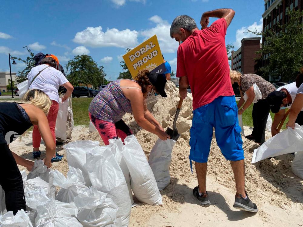 Residents fill and collect sand bags before the expected arrival of Hurricane Isaias in Doral, Florida, U.S. July 31, 2020. -Reuters