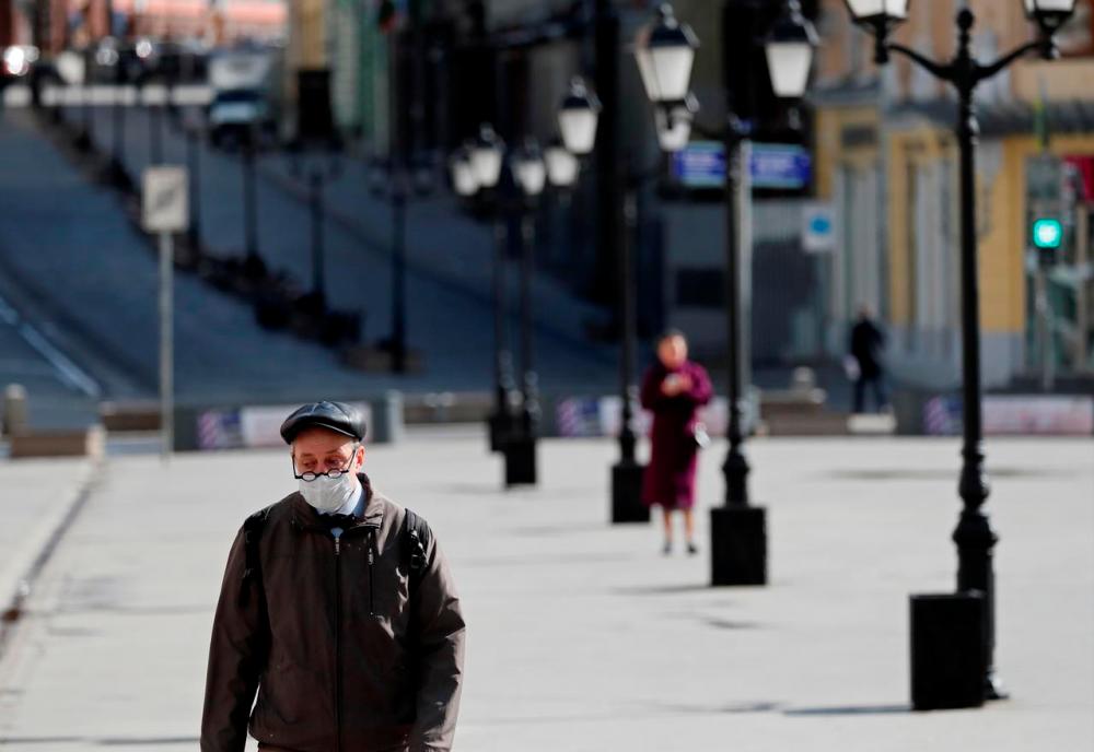 A man wearing a protective face mask walks along the street, as the spread of the coronavirus disease (COVID-19) continues, in Moscow, Russia April 10, 2020. -Reuters